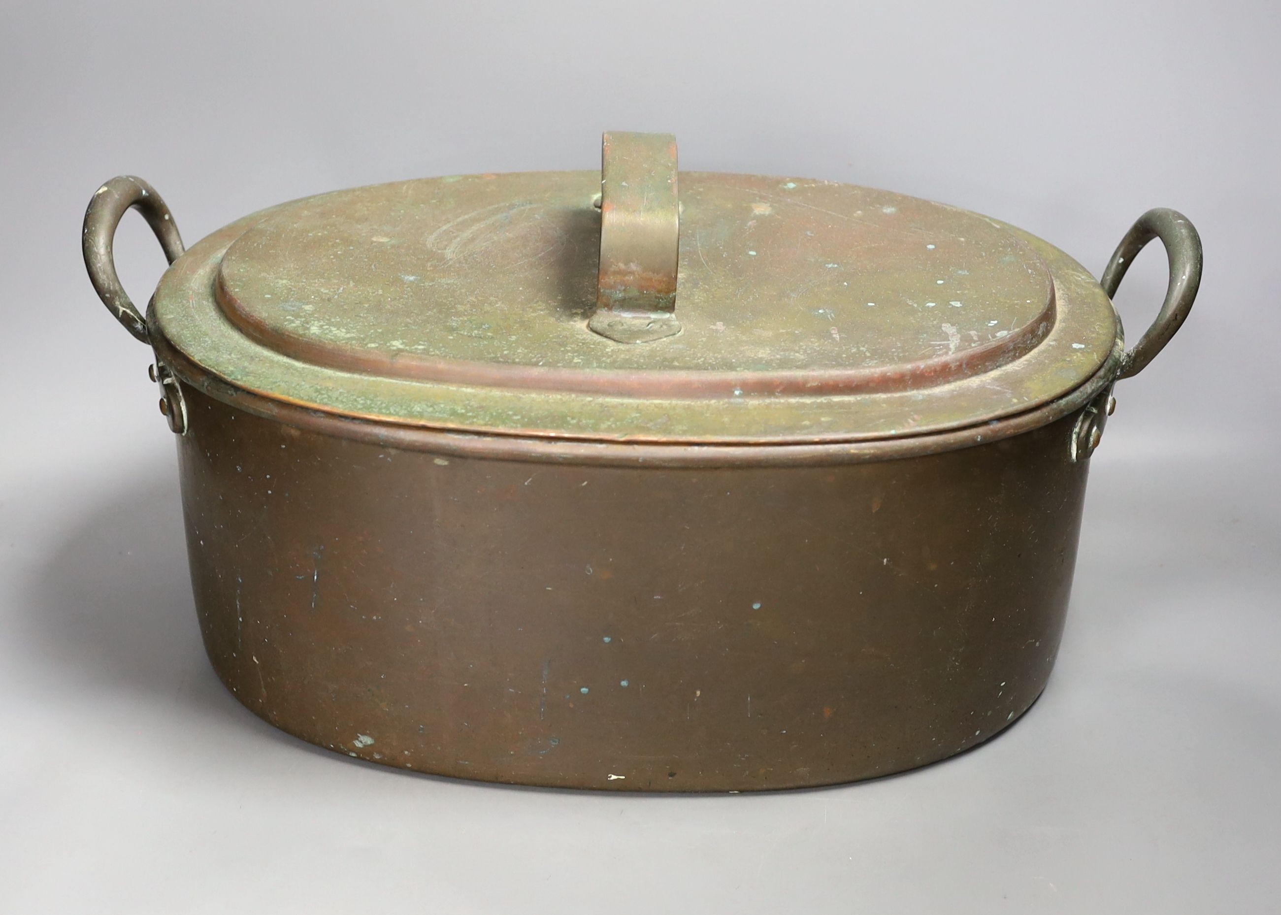 A Victorian oval copper two handled preserve pan and cover., 35cms wide.